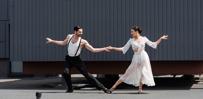 cheerful ballroom dancers holding hands on roof of 2023 11 27 05 07 22 utc