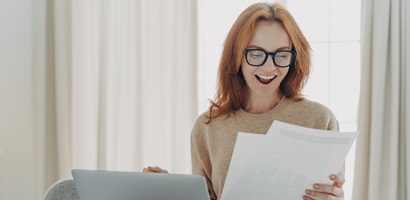 happy excited redhead woman reading paper letter w 2023 11 27 05 34 51 utc