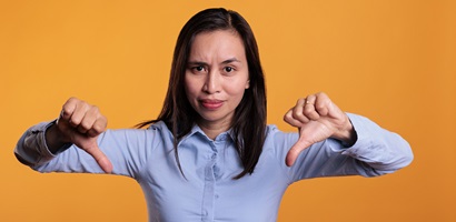 unhappy asian model giving thumbs down negative si 2023 11 27 04 58 03 utc